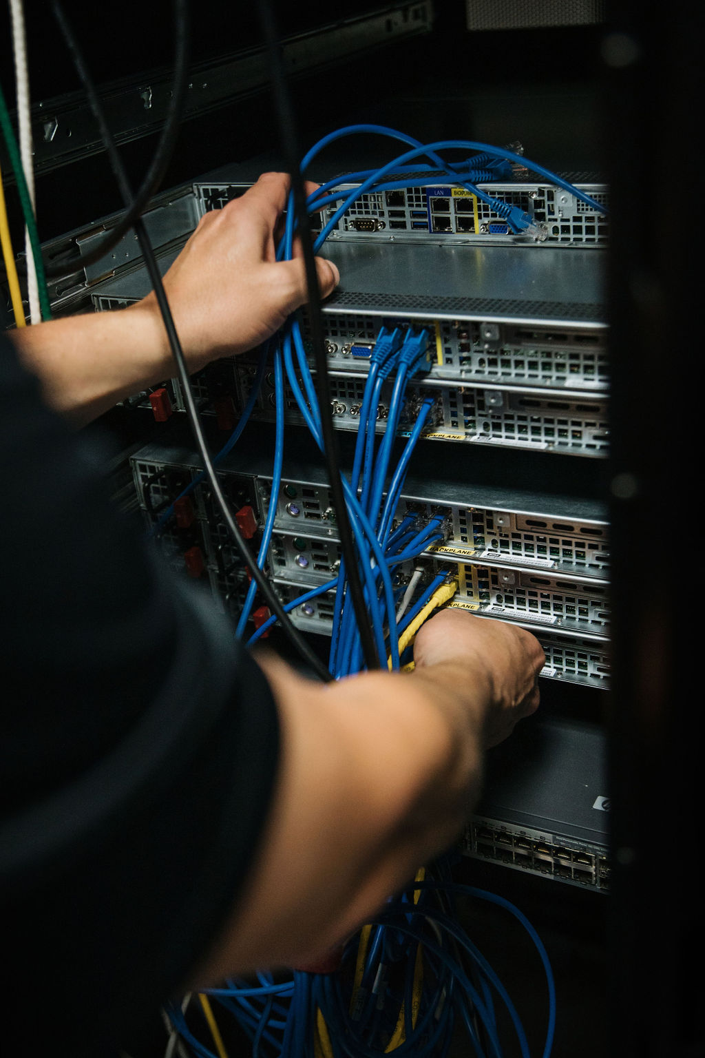 Technician cabling a server rack
